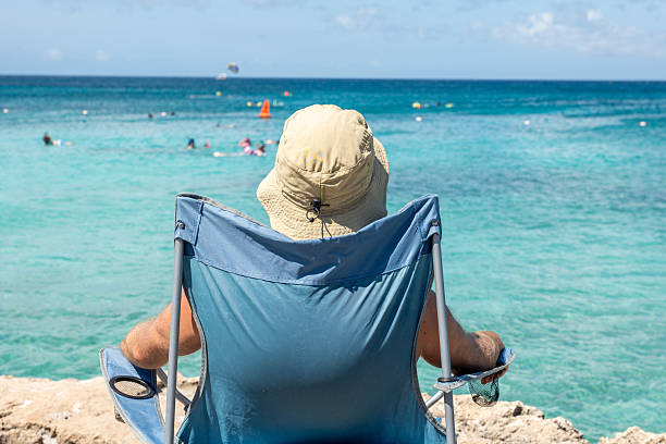 istock Relaxed Man Enjoying Ocean View from Beach Chair 2206654407