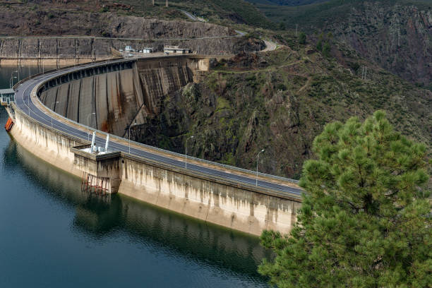 istock Curved dam retaining water in reservoir on overcast day 2206657649