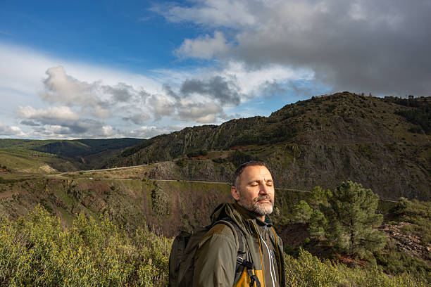 Hiker breathing fresh air in the mountain valley while hiking