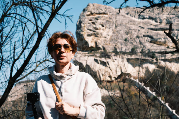 Female tourist is using wearable camera in mountains