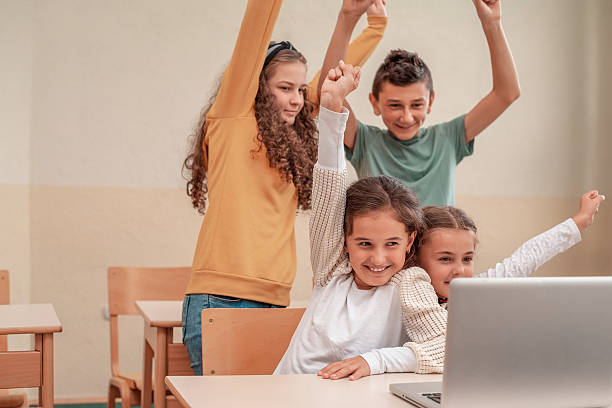 istock Happy group of student using a laptop at the school class in the classroom. 2206658470