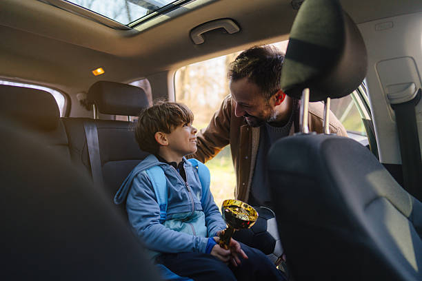 istock Proud father and his son with a trophy 2206658636