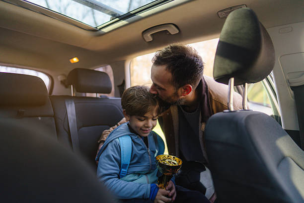 istock Proud father and his son with a trophy 2206658651