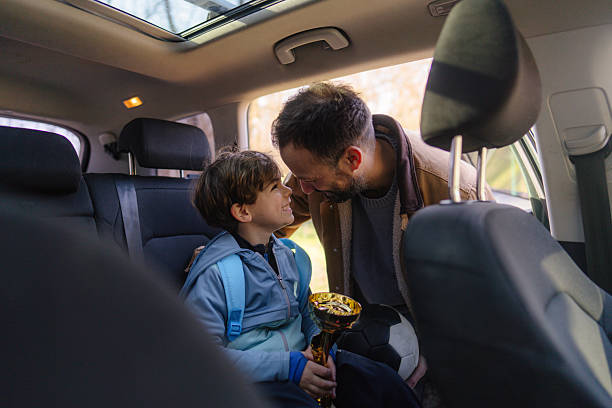 istock Proud father and his son with a trophy 2206658710