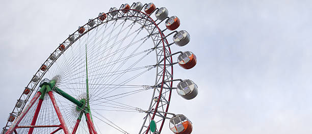 istock Ferris wheel with clouds and sky 2206662135