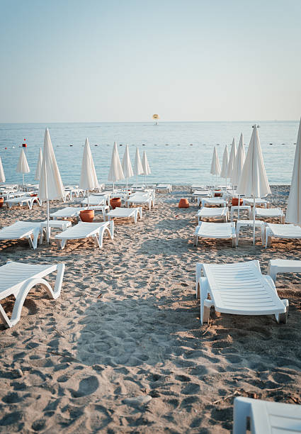 istock Empty Beach with Sun Loungers and Umbrellas at Sunrise 2206662273