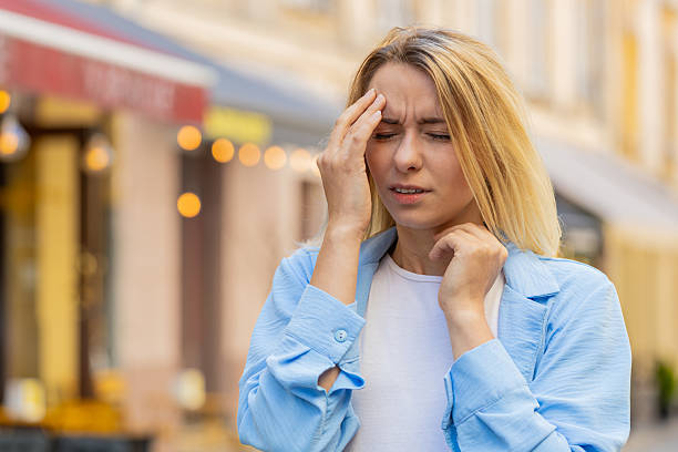 istock Displeased exhausted woman rubbing temples to cure headache problem suffering from tension migraine 2206663427