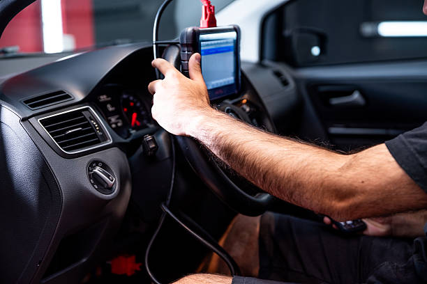 istock Automotive diagnostic scanner connected to the vehicle system 2206667180