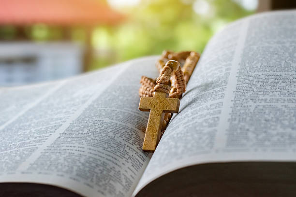 istock Wooden cross rosary on bible 2206667554