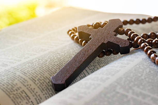istock Wooden cross rosary on bible 2206668456