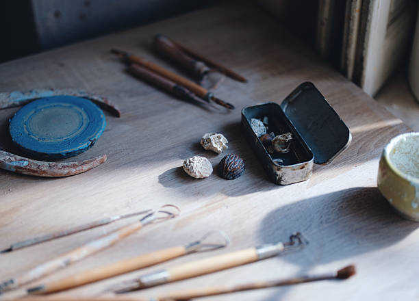 istock Artisan Pottery Tools Arranged on a Wooden Table in Natural Light 2206668612
