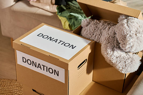 istock Clothes prepared for donation in cardboard box 2206671120