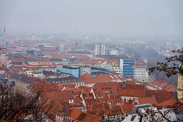 Graz cityscape on foggy day. Panoramic view of Graz, Austria with historical architecture. Streets with red roofed buildings in European city