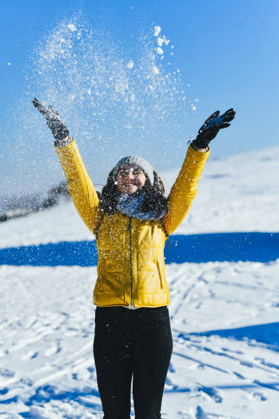 Happy Female Laughing As She's Throwing Snow Over Her Head