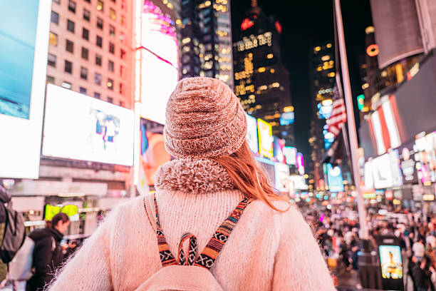 istock Woman in Cozy Attire Exploring Times Square at Night 2206674157