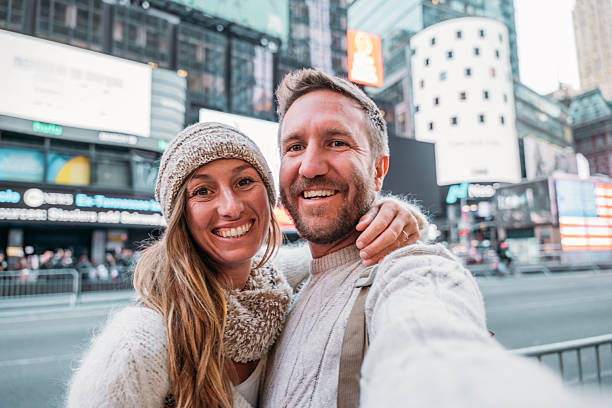 istock Smiling Couple Taking Selfie in Times Square 2206674158