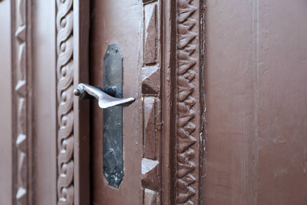 Old, carved wooden door on the red facade of the building. Entrance to the house, architecture of the Scandinavian city. Gamla Stan.  Stockholm, Sweden