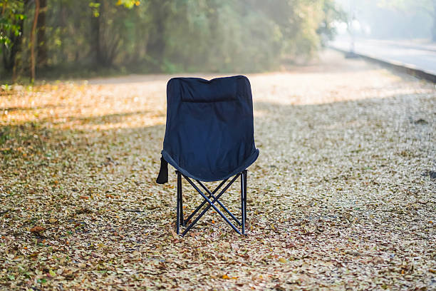 istock Foldable Chair in Outdoor Autumn Setting Surrounded by Dry Fallen Leaves 2206675259