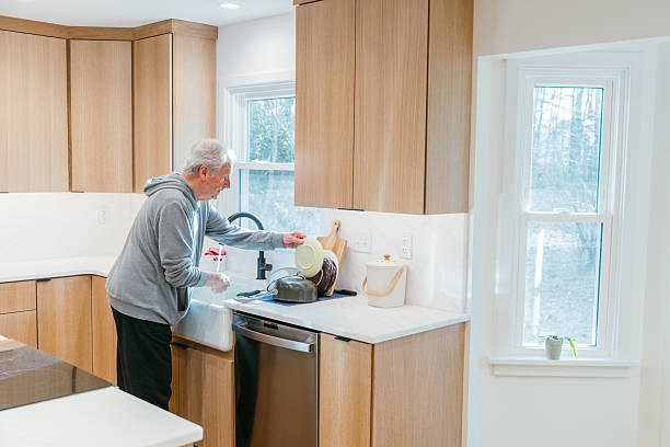 istock Senior man doing the dishes 2206676326