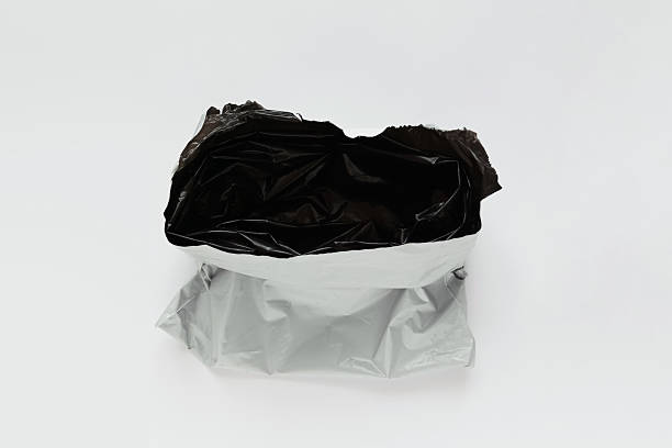 istock Opened packaging bag gray black color. White background. 2206676954