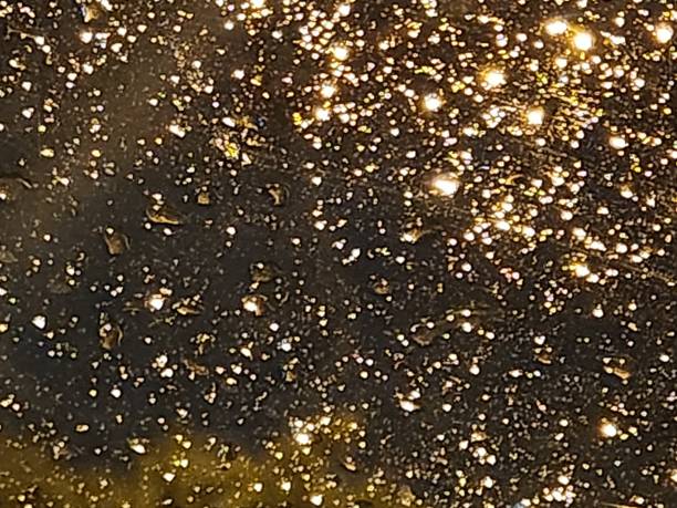 istock Tiny raindrops rest on the glass at night, capturing the city's diffuse reflections. The contrast between darkness and multicolored glows turns the scene into a spectacle of light and water, marked by fleeting and dynamic patterns. 2206678296