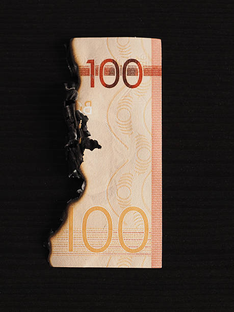 istock Burnt hundred Dominican peso banknote. Inflation concept. 2206678404