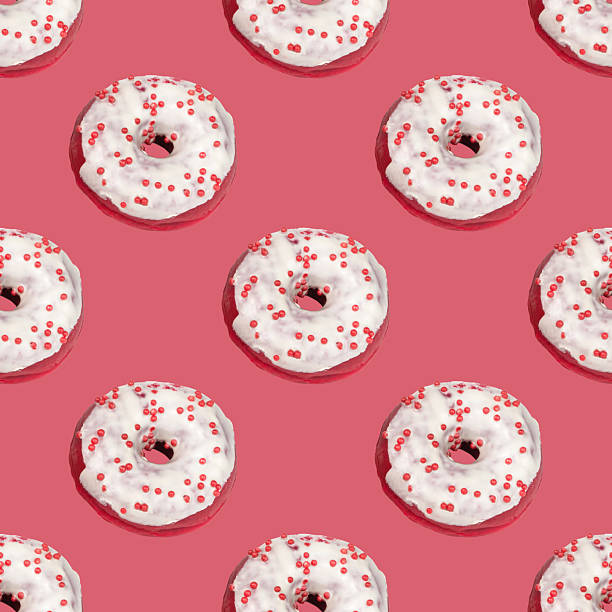 istock Pattern of donuts made of red dough with white icing on a pink background 2206678754