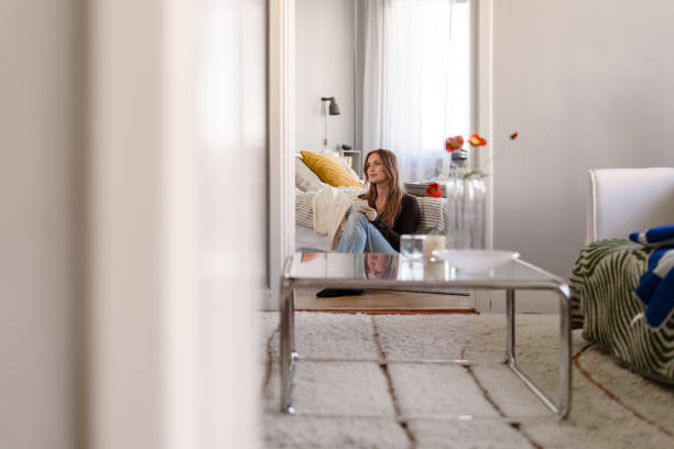 istock Young woman writing notes while sitting comfortably indoors 2206681436