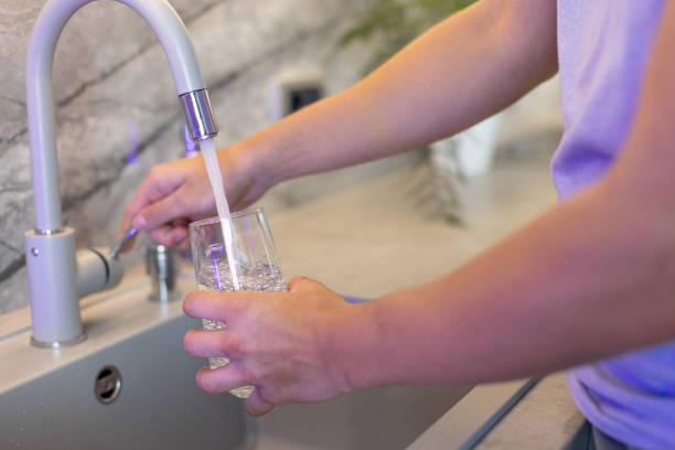 istock Filling a Glass with Fresh Drinking Water from a Kitchen Tap 2206682743