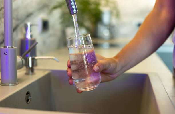 istock Filling a Glass with Fresh Drinking Water from a Kitchen Tap 2206682748