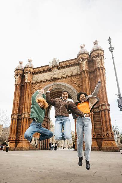 istock Tourists jumping in front of arc de triomf in barcelona 2206683041