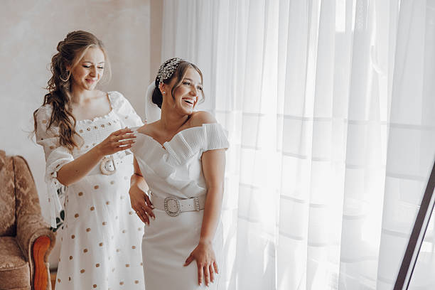 istock Two women are standing in front of a window 2206684628
