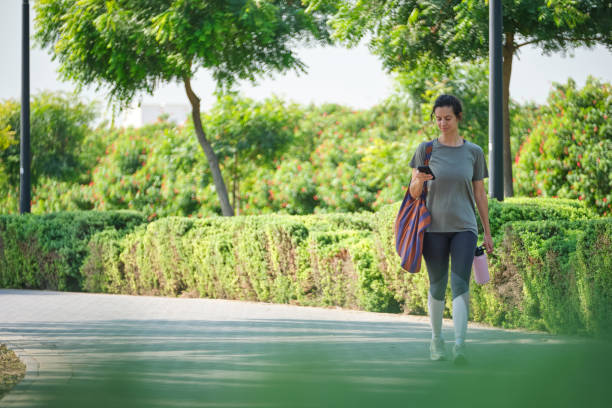 istock Woman using smart phone in public park 2206685455