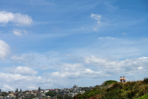 Sydney, Australia - February 15, 2025: Two people walk at Mackenzie's Point on the Bondi to Bronte Coastal Walk.
