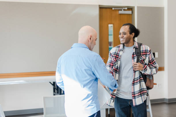 istock Professor and Student Talking in University Hallway 2206686188