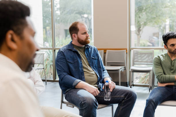 istock Group Therapy Session: Diverse Adults Discussing Mental Health 2206686213