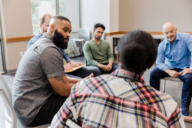 istock Group therapy session: diverse adults discussing mental health 2206686247