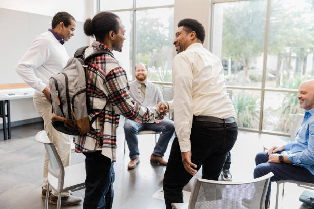 istock Diverse Group of Adults Shaking Hands in a Meeting 2206686260