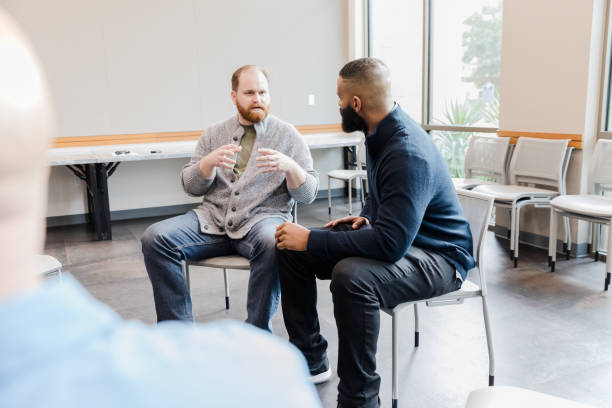 istock Two Men in Casual Clothing Having a Discussion During Group Therapy 2206686264