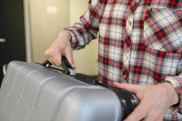 istock Female Hands Packing a Suitcase on a Bedroom Bed, Close-Up 2206686749
