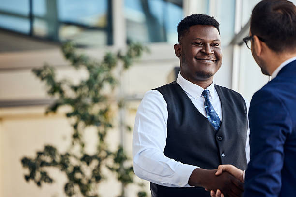 istock Businessmen Shaking Hands in Corporate Setting with Blue Suit and Friendly Smile 2206687093