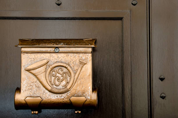 istock Unique Hungarian Mailbox Design Featuring a Decorative Brass Horn on a Wooden Door 2206689137
