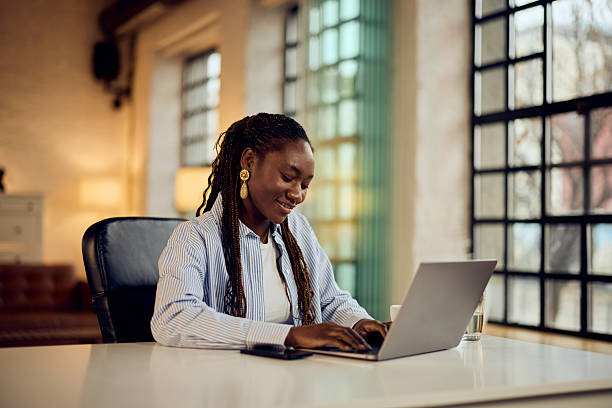 istock Professional Woman Working on Laptop in a Modern Office Environment 2206689435