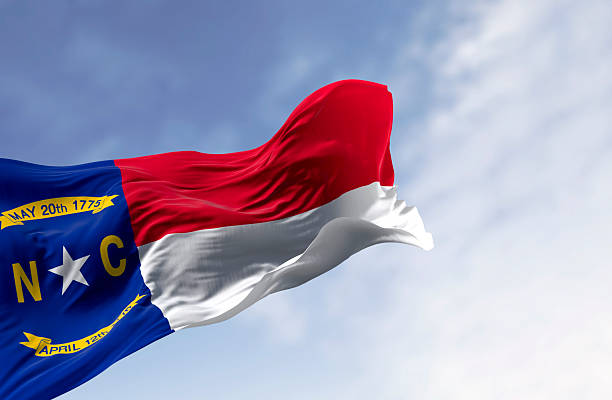 istock North Carolina flag waving on wind against clear sky, 3D render 2206690399