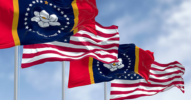 istock Mississippi and US flags waving together under clear blue sky 2206690412