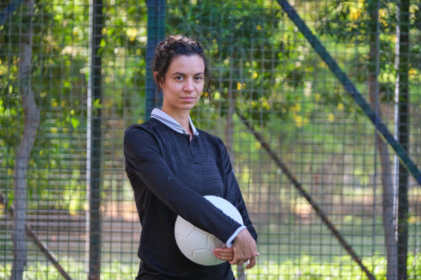 istock Confident female player standing with basketball 2206690826