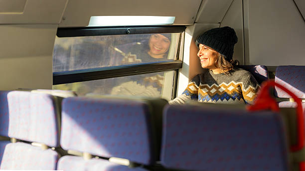 istock A smiling passenger enjoying a scenic train ride. 2206691315