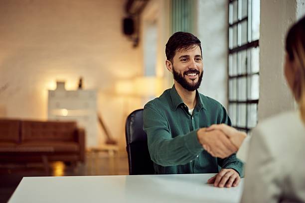 istock Two Business Professionals Shaking Hands in a Modern Office Setting 2206691465