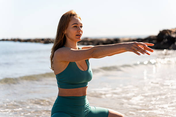 istock Ukrainian woman practicing yoga breathing exercises on spanish beach 2206691948