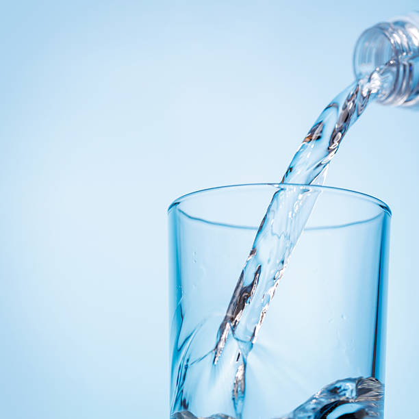 istock Crystal clear water being poured into a transparent glass, creating refreshing ripples and bubbles 2206692132